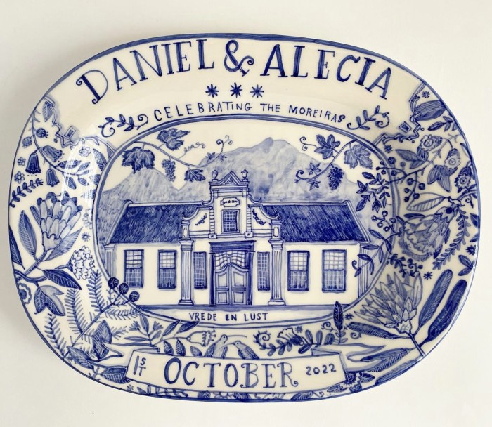 blue and white plate with house on it