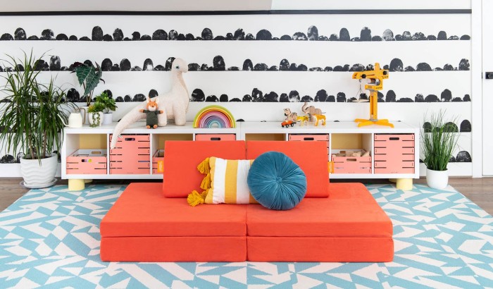 Coral nugget play couch in front of black and white wall