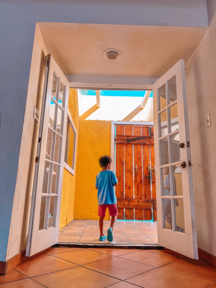 Child walking through French doors