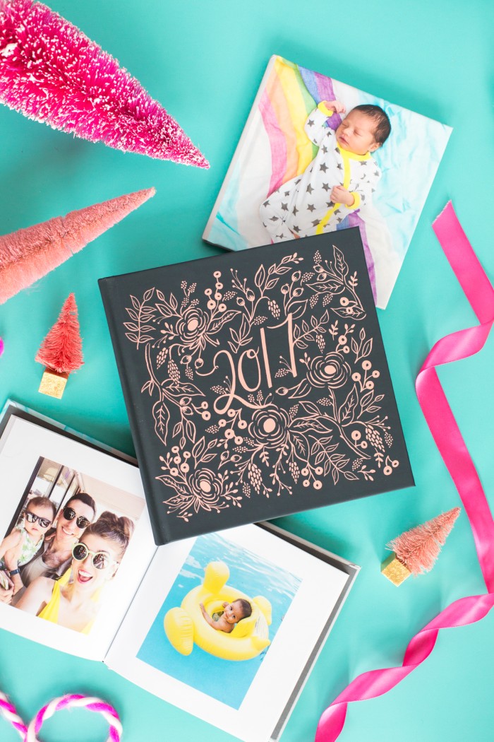 Photo books laying on blue table with ribbon