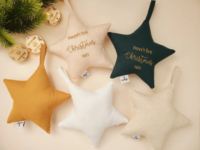 star ornaments with "baby's first christmas" written on them