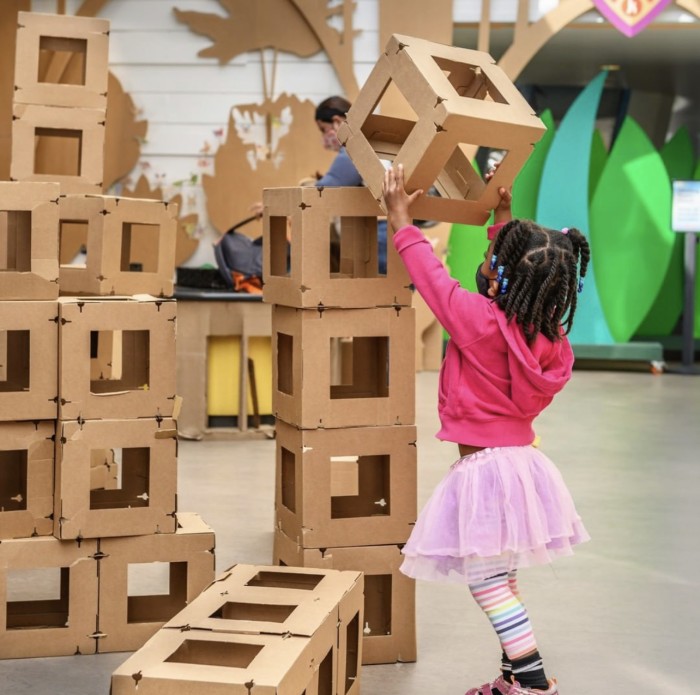 Girl stacking large blocks