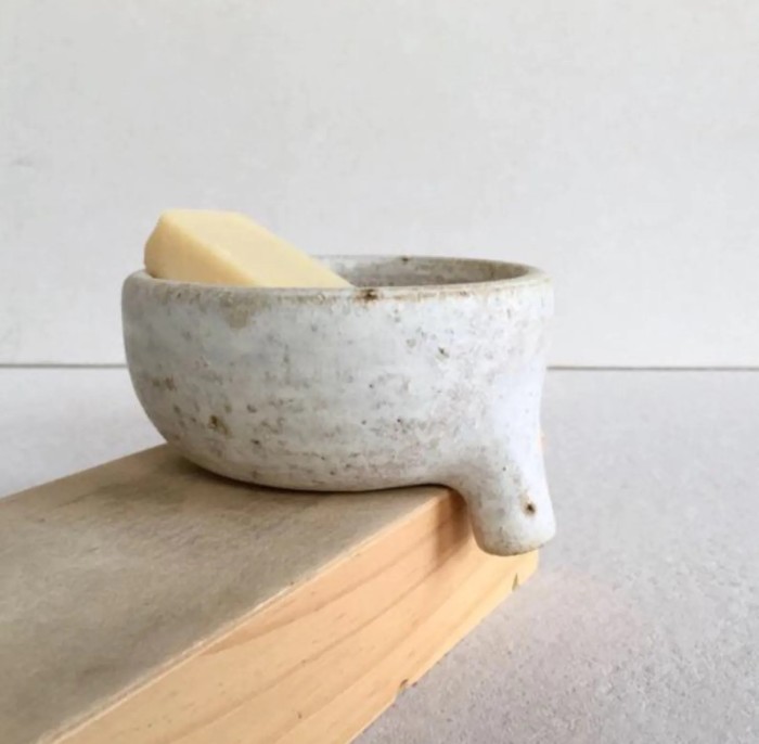 ceramic soap dish with drain on wood board