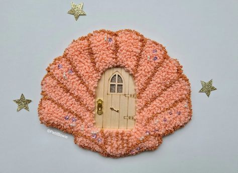 Fairy door with pink sewed shell surrounding it