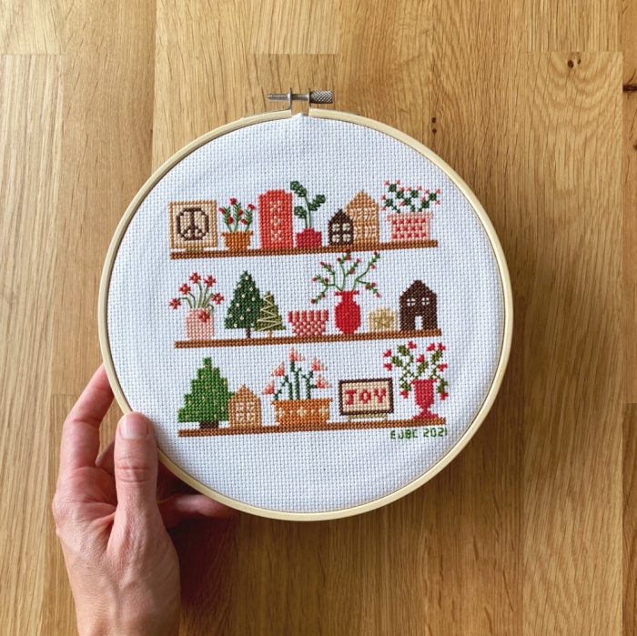 Christmas on shelves with houses, trees, and signs