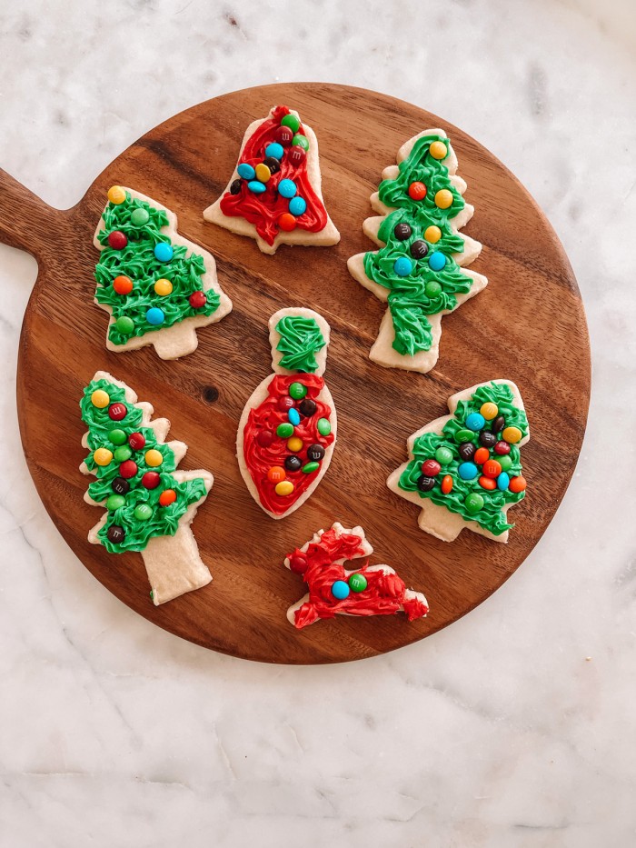 Decorated Christmas cookies on a wood cutting board