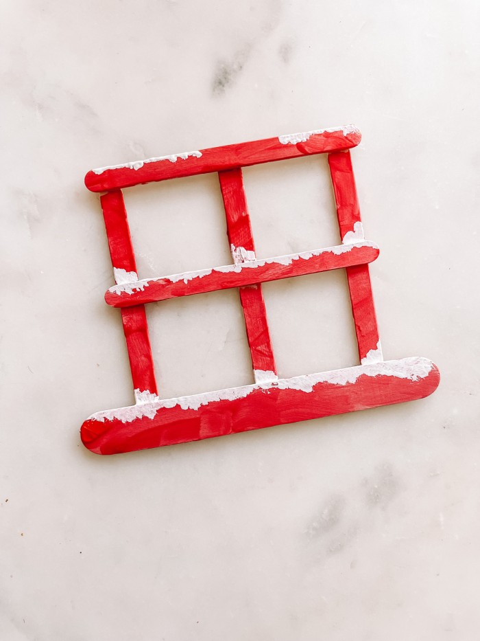 Red and white painted Popsicle stick window