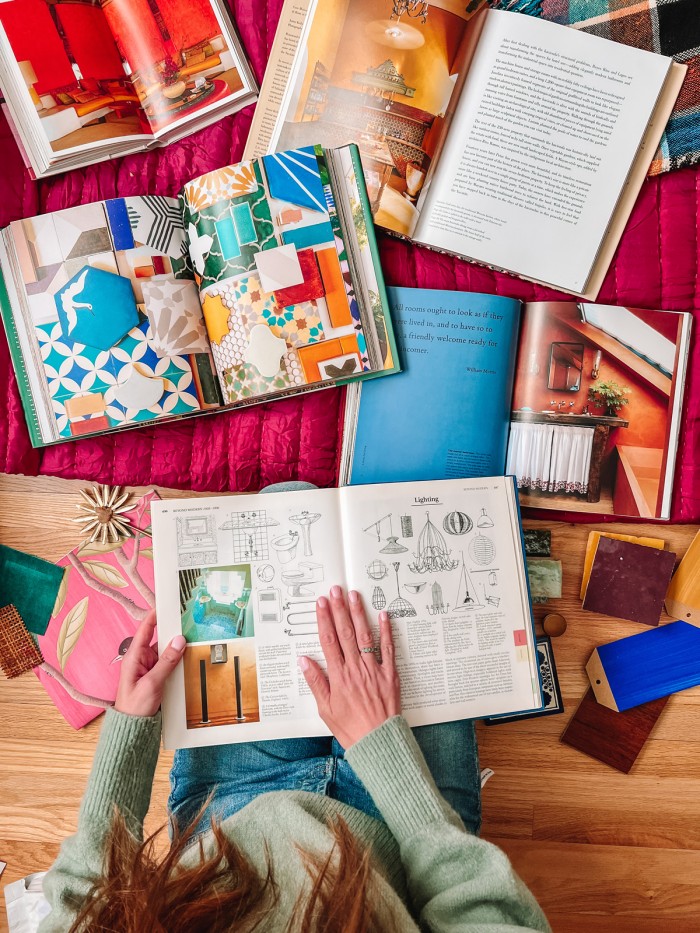 Colorful interior design books open on a blanket