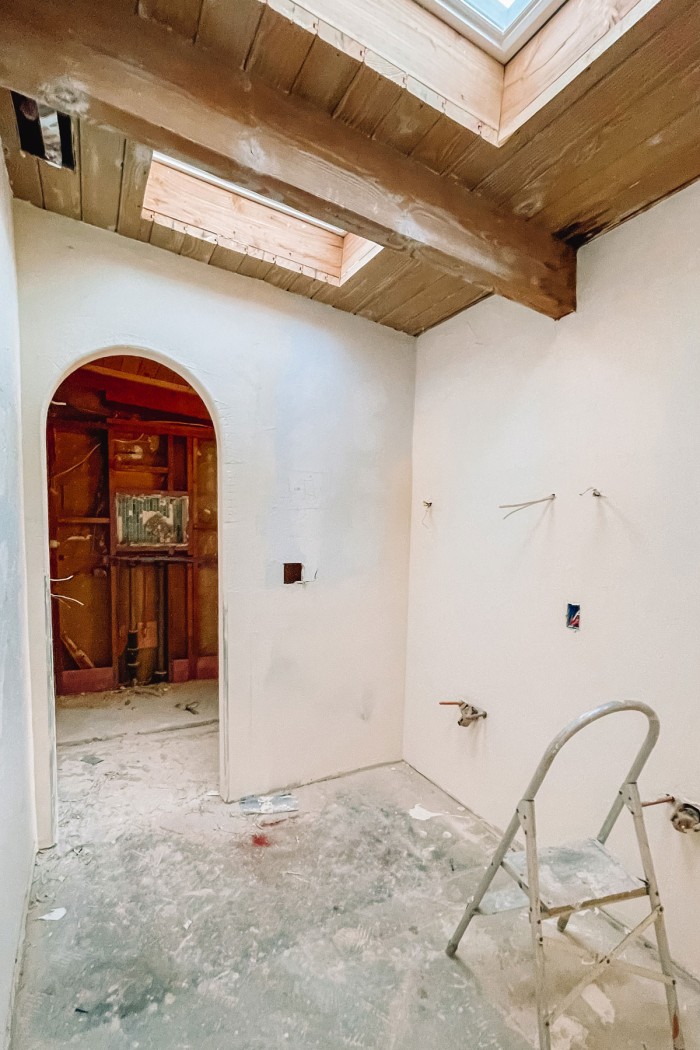 bathroom under construction with arch and wood ceilings