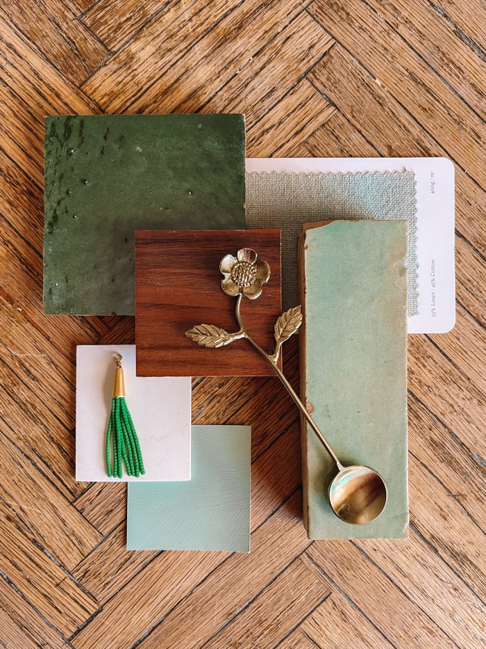Green bathroom swatches on wood table