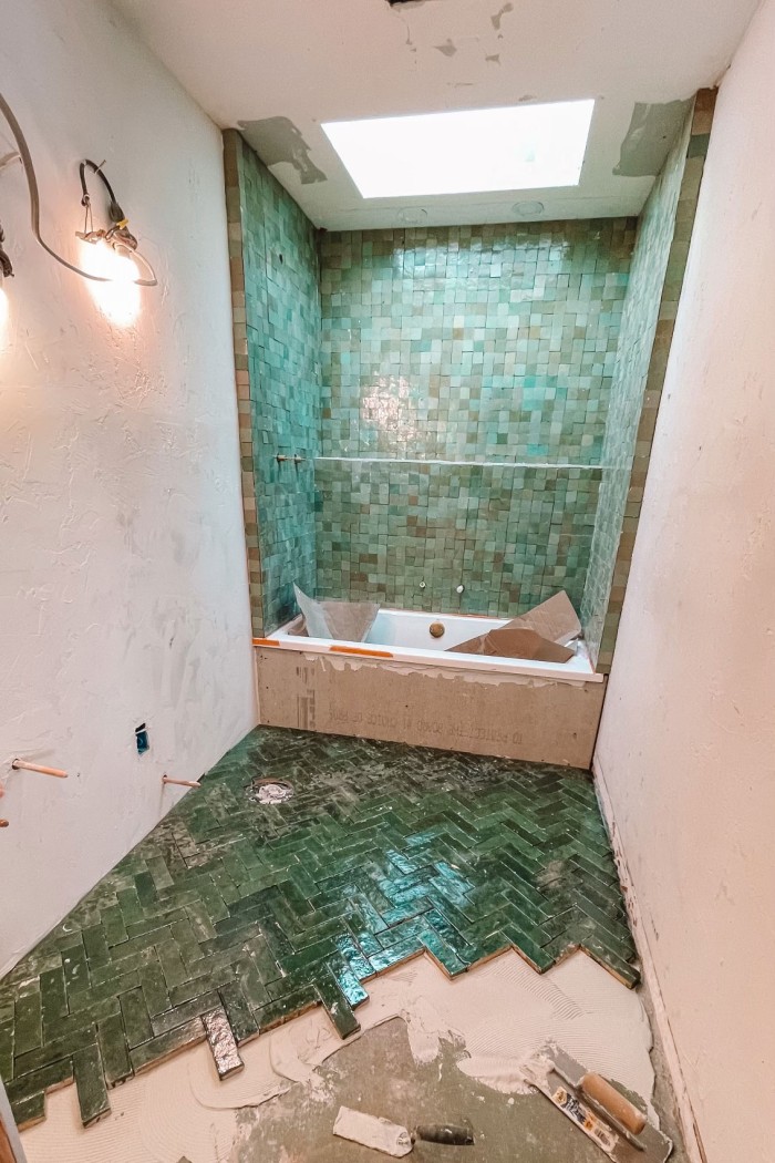 green tile bathroom being renovated
