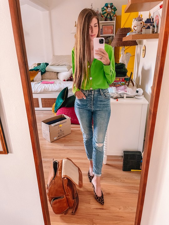 girl standing in mirror in messy room