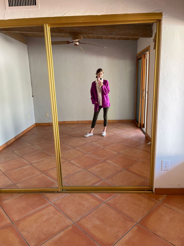 girl standing in front of mirrored closet doors