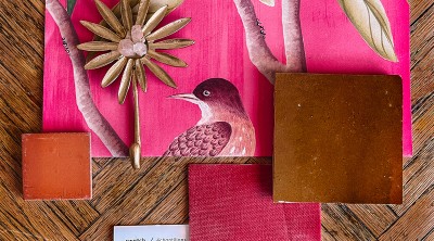 pink wallpaper and tile samples on wood table