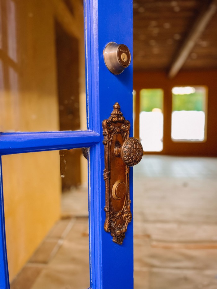 Blue front door with antique brass hardware