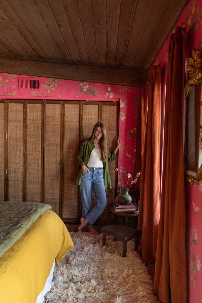 woman standing in front of rattan closet doors in bedroom