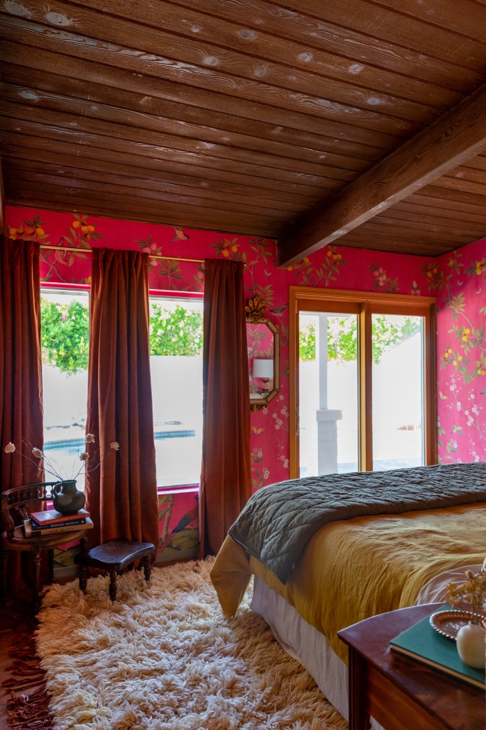 pink bedroom with curtains and bed in front