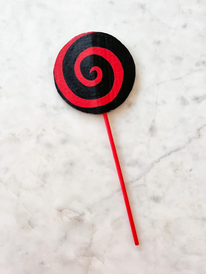 Red and Black Lollipop on marble table