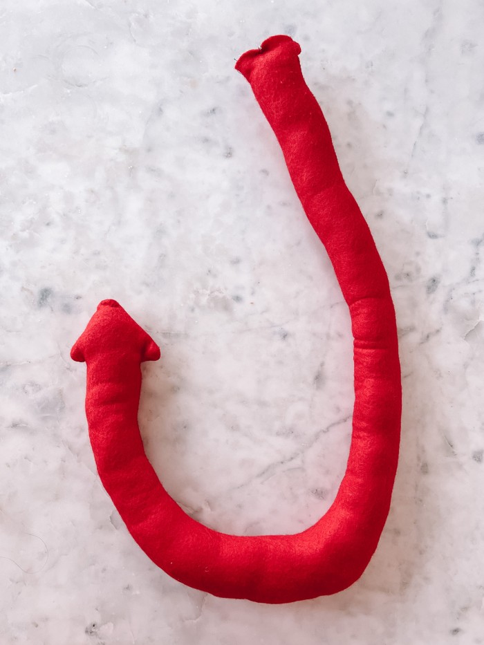 red felt devil tail on marble table