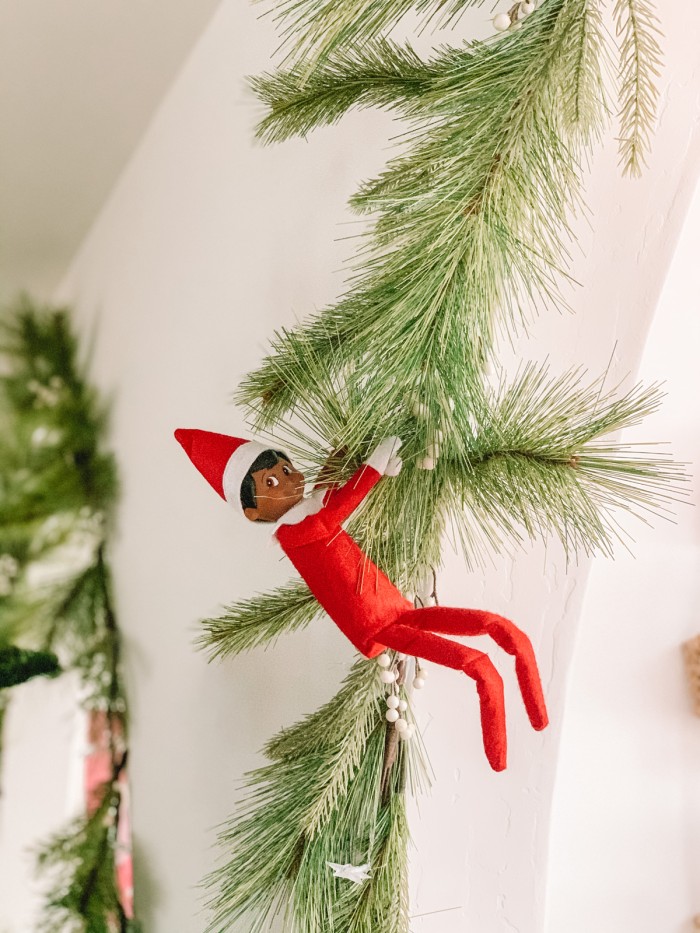 elf hanging from garland