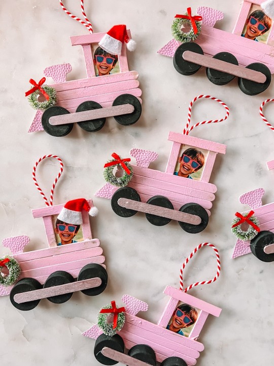 Popsicle stick train Christmas ornaments on marble table