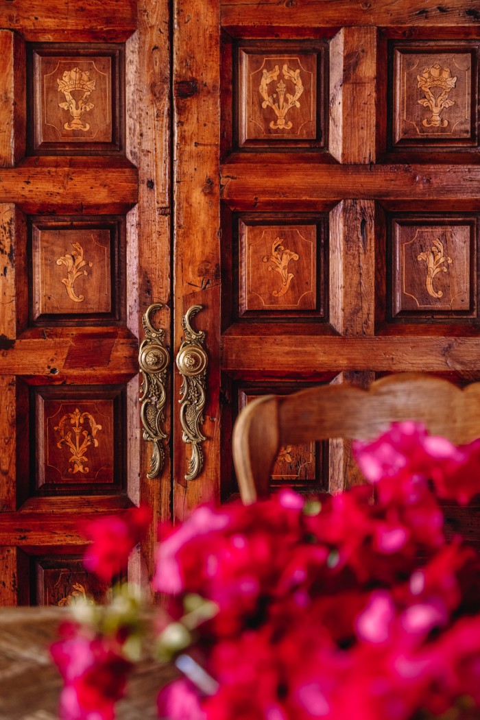wood doors with bougainvillea in front
