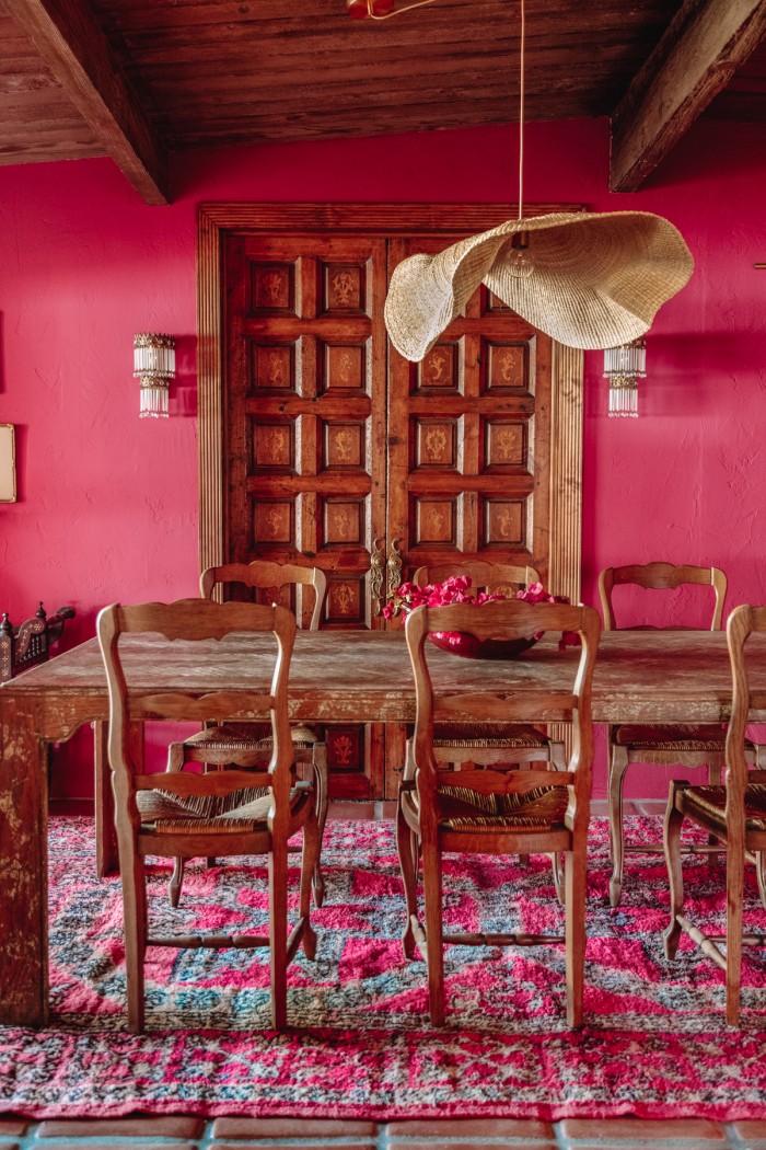 wood doors behind table in pink dining room