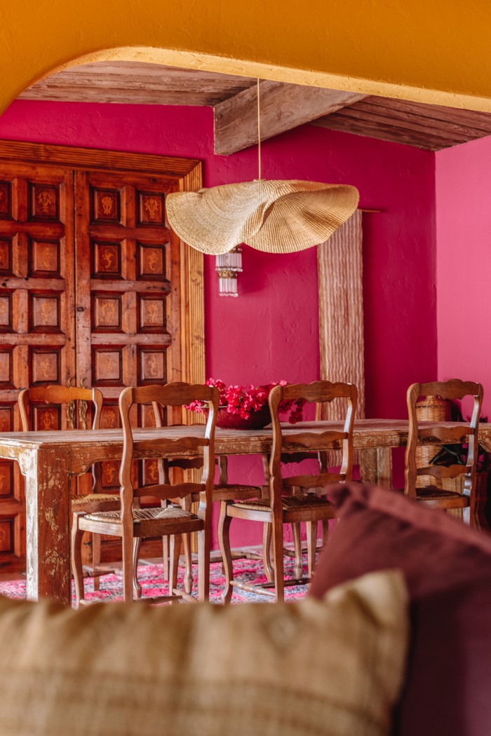 pink dining room with wood doors