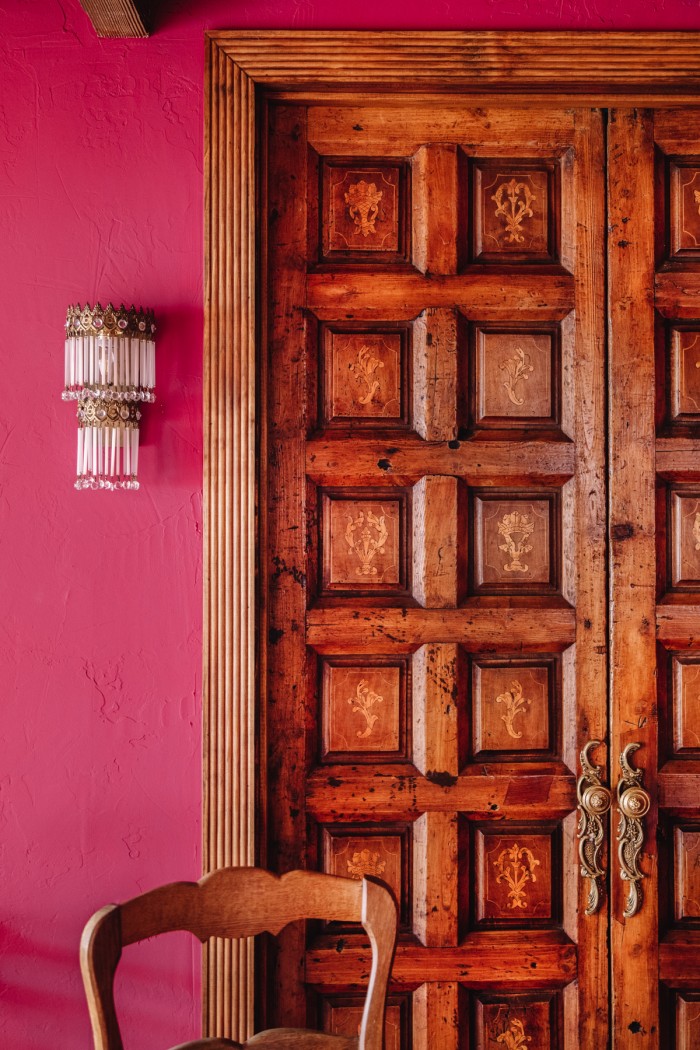 wood doors and a pink wall
