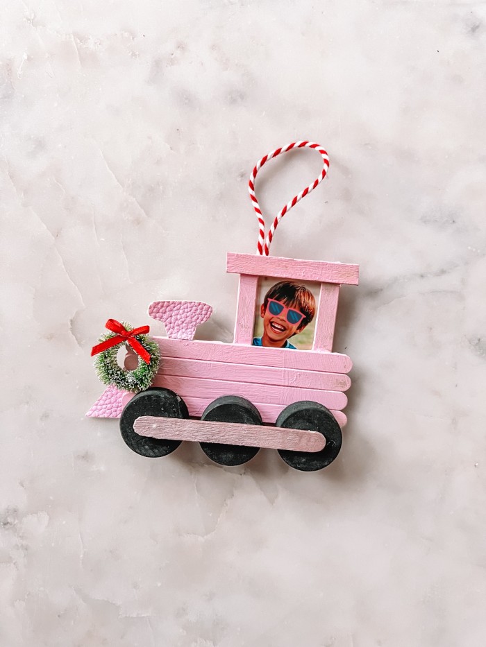 Popsicle Stick Train Christmas Ornament on marble table