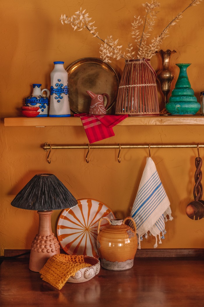 table lamp under shelf in yellow kitchen