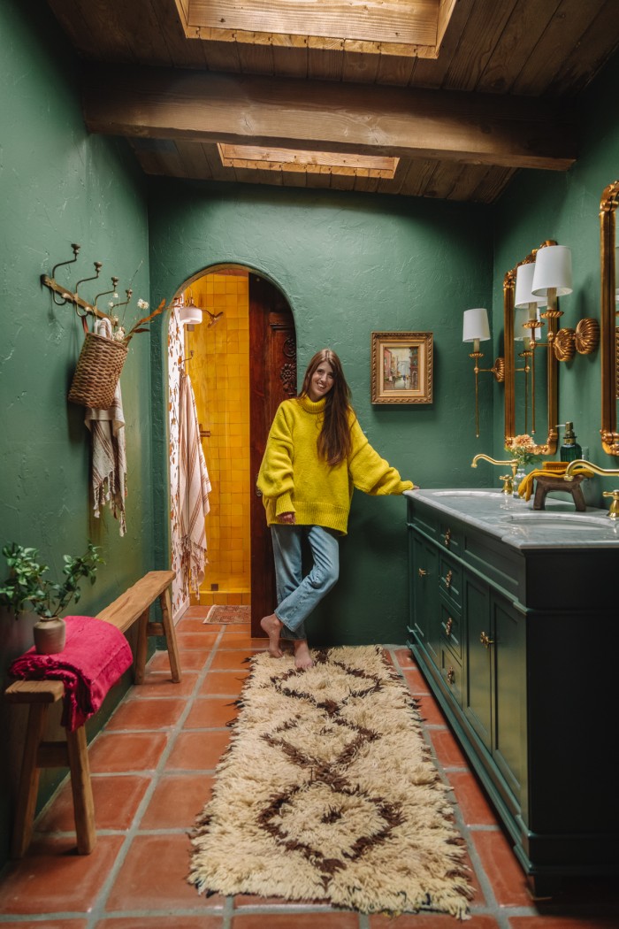 woman standing in green bathroom