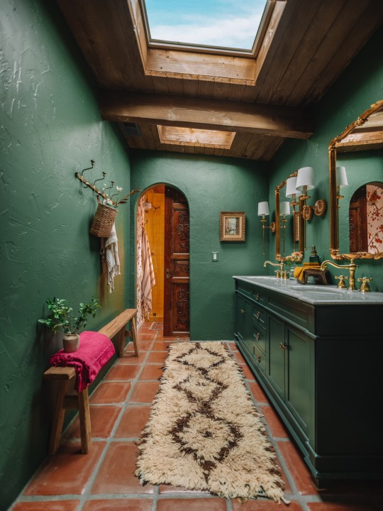 A Dark Green Bathroom with Unexpected Details