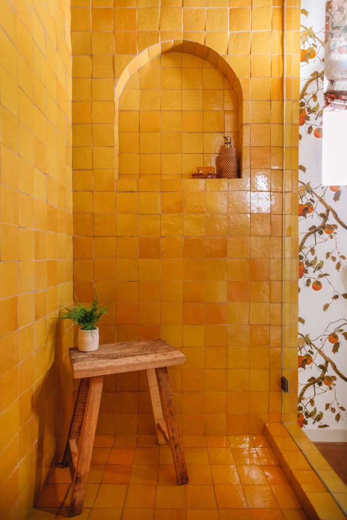 yellow tile shower with arch niche