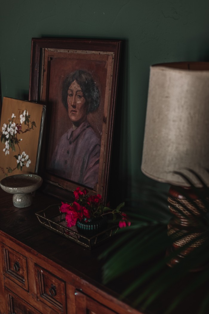 antique oil painting on credenza in green room