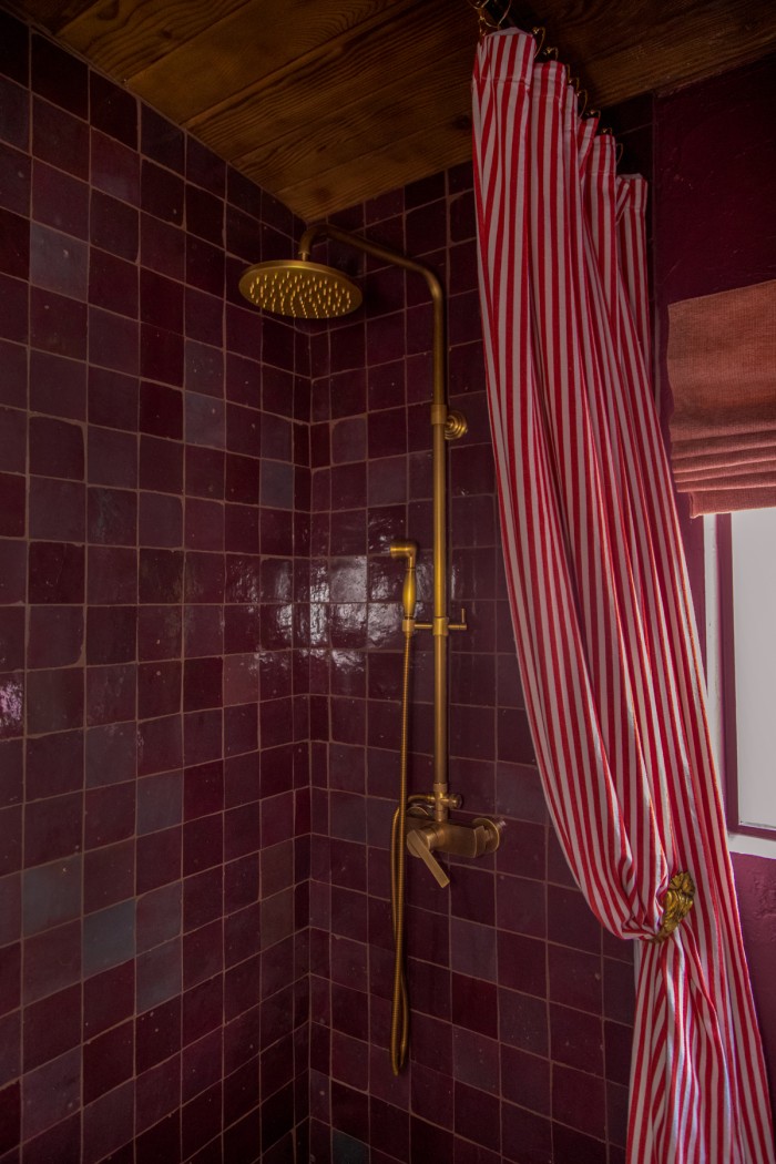 purple tile shower with red stripe shower curtain