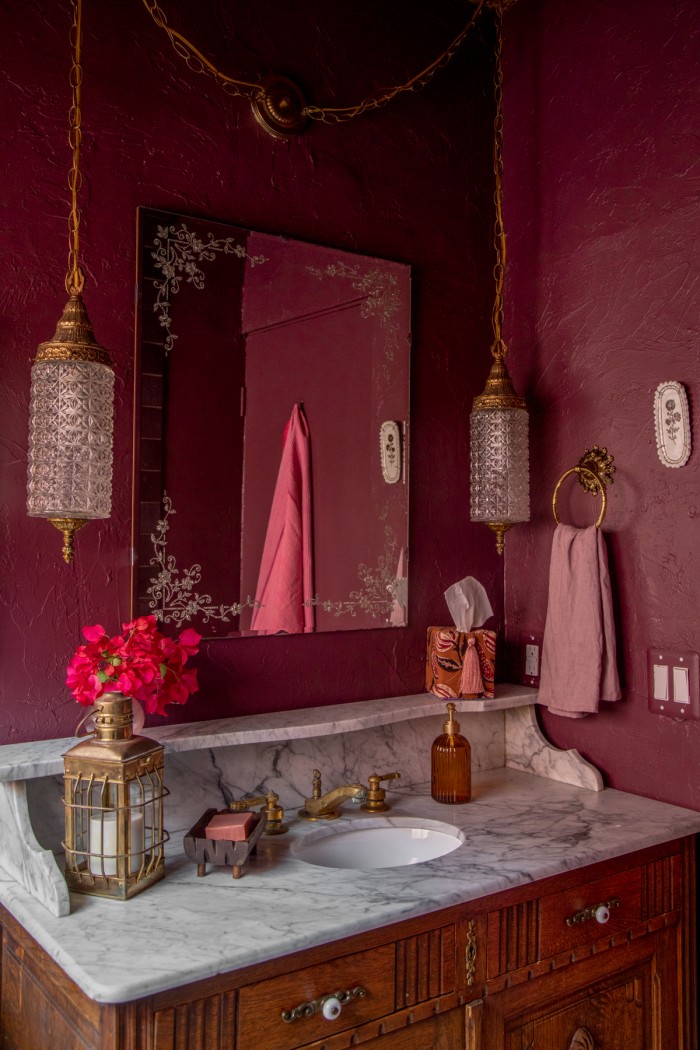 purple bathroom with hanging crystal pendants