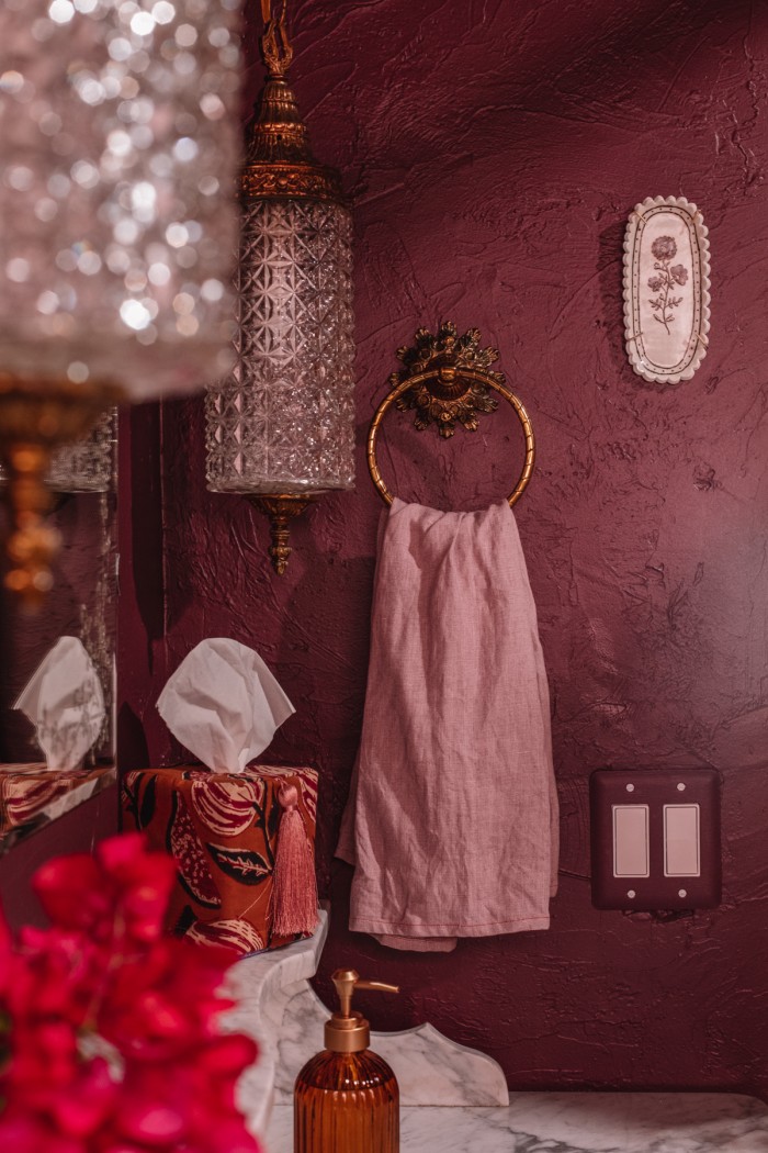 Purple bathroom with gold towel hook and purple towel