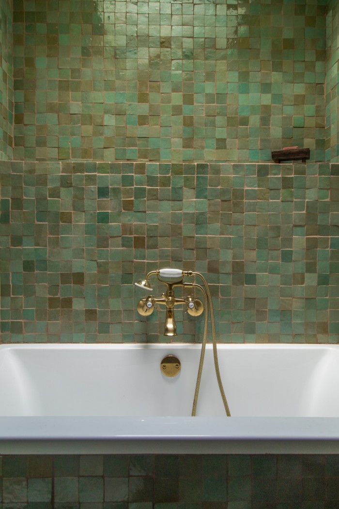 sage green tile above bathtub