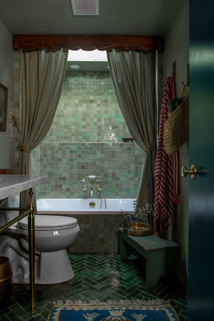 sage green bathroom with shower curtains