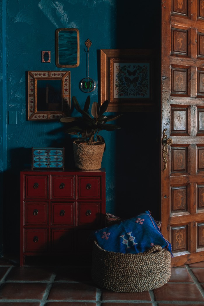 red chest of drawers in teal room