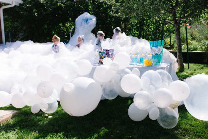 Bubble party with bubbles and balloons outside.