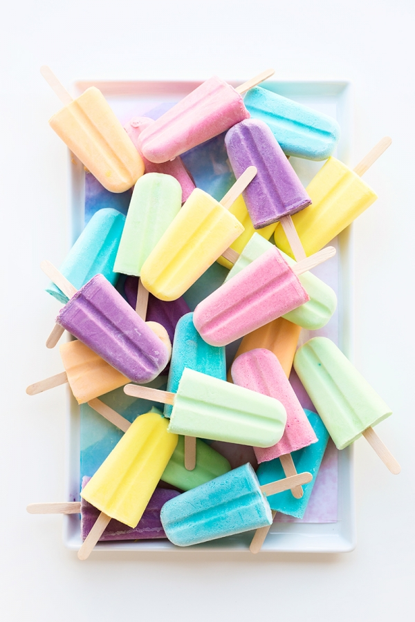 Popsicles stacked on a table.