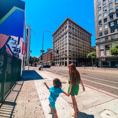 woman and child walking down street in Downtown Los Angeles