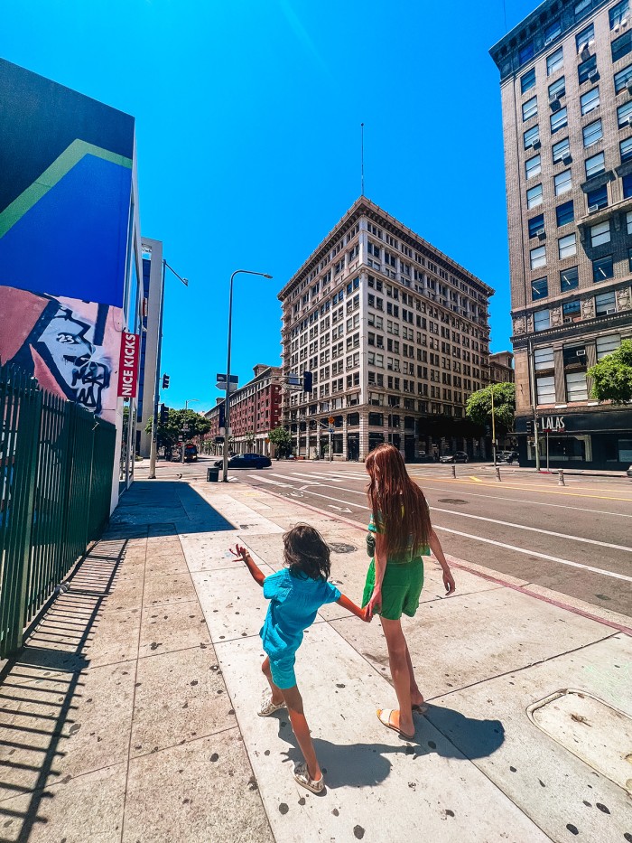 woman and child walking down street in Downtown Los Angeles