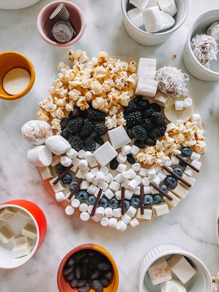 jack skellington dessert board on marble table with bowls around it