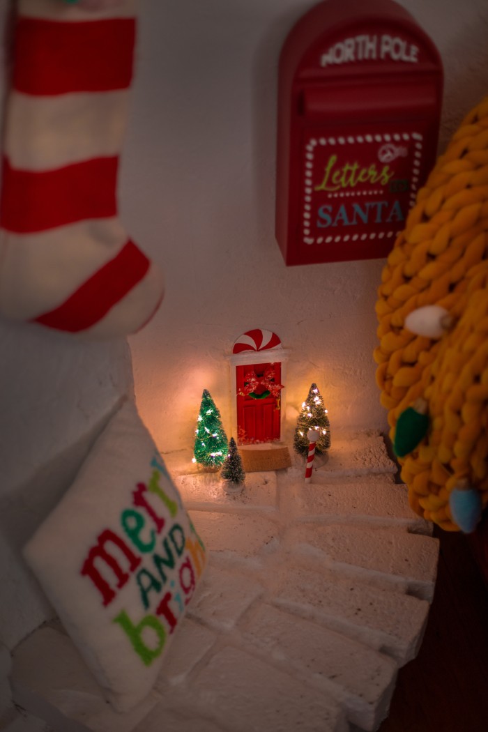 elf door on a wall with christmas decorations