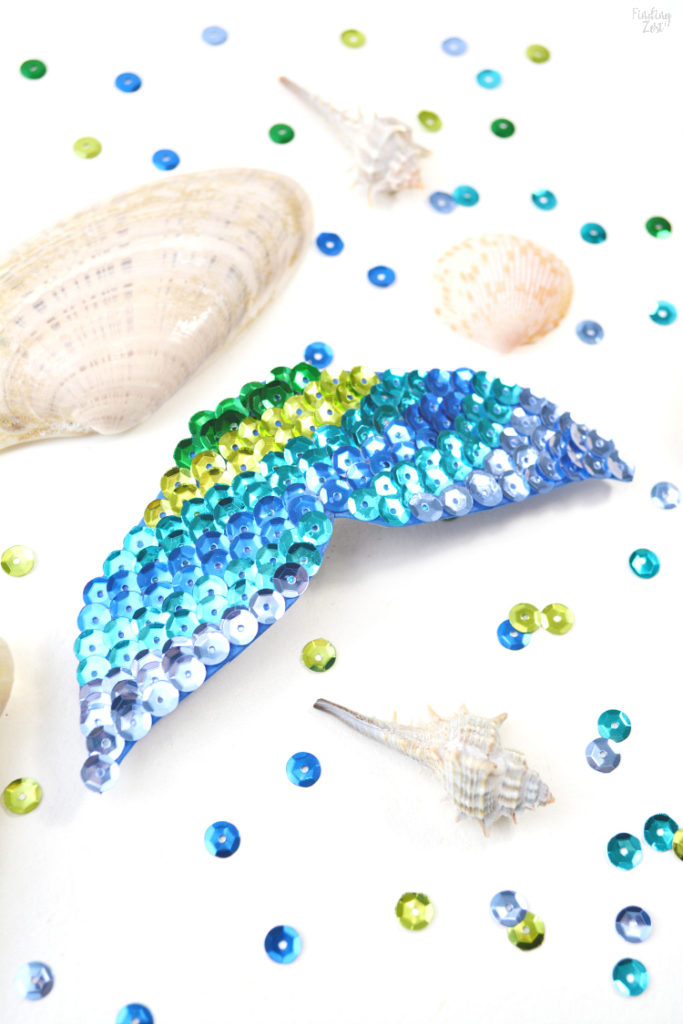 Mermaid fin hair clip on a table with sequins