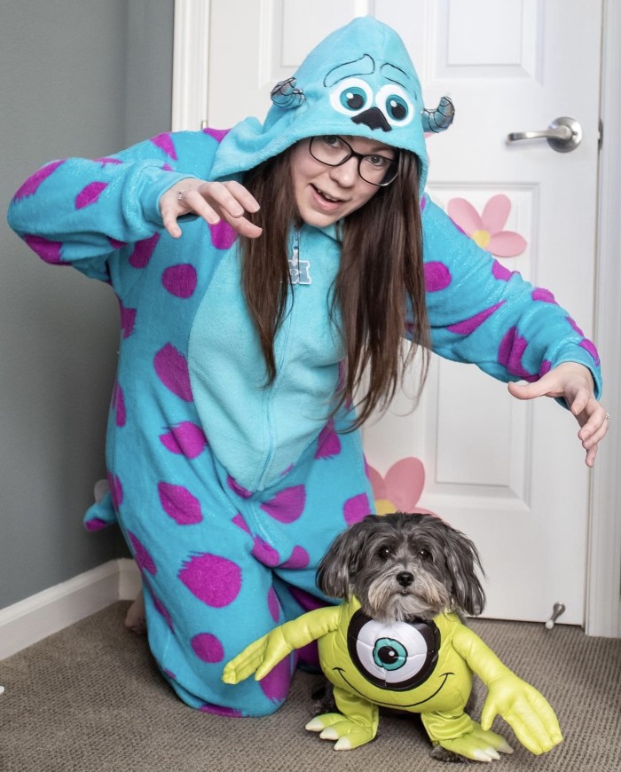 dog dressed up as Mike Wazowski and person dressed up as Sully from Monster's Inc