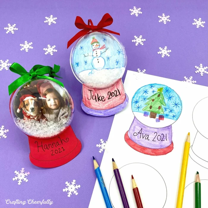 Snow globe ornaments with colored pencils next to them. 